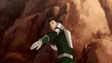 a man in a green and white outfit is standing in front of a rock wall