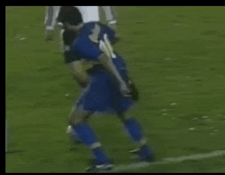 a soccer player with the number 10 on his shorts is being tackled by another player on the field .