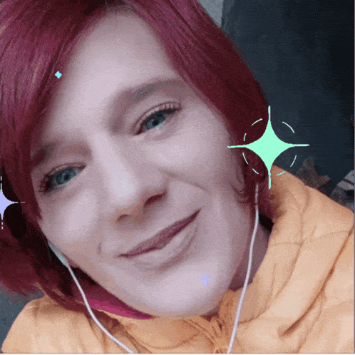 a woman with red hair is smiling and wearing earbuds