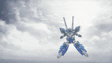 a blue and silver robot is flying through the air with a cloudy sky in the background