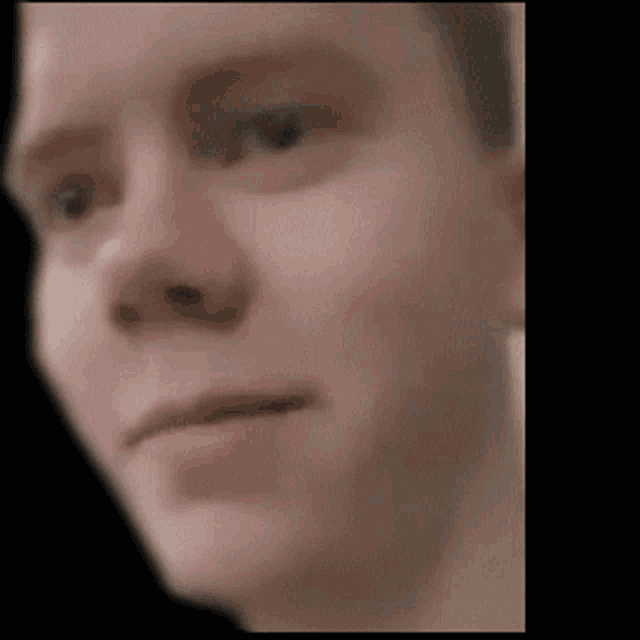 a man 's face is shown in a blurry photo