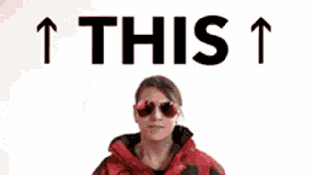 a woman wearing sunglasses and a plaid jacket is pointing up with the word this above her head