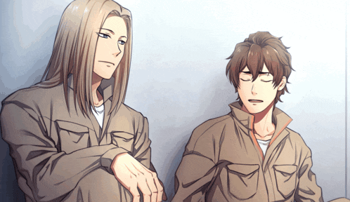 a man with long hair is sitting next to another man