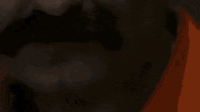 a close up of a woman 's mouth with red lips and white teeth