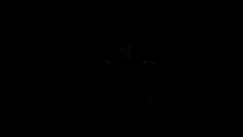 a person 's face is visible in the dark with their mouth open