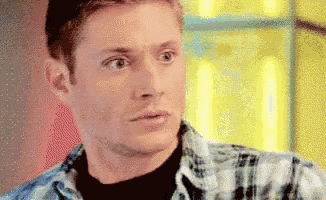 a man in a plaid shirt is looking at something