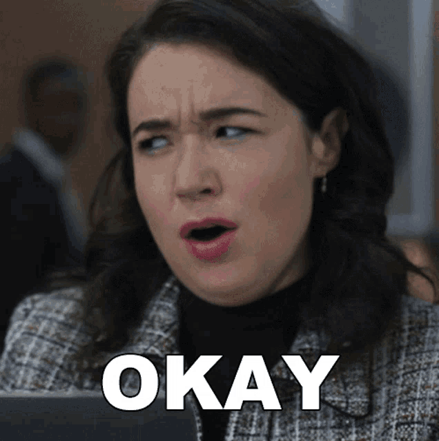 a woman with a surprised look on her face has the word okay above her head