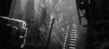 a black and white photo of a city at night with a lot of buildings .