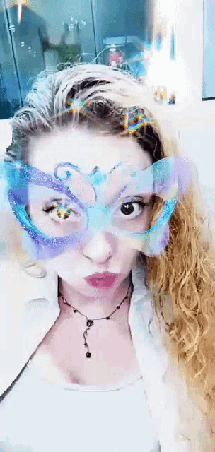 a woman wearing a mask with a butterfly design on her face
