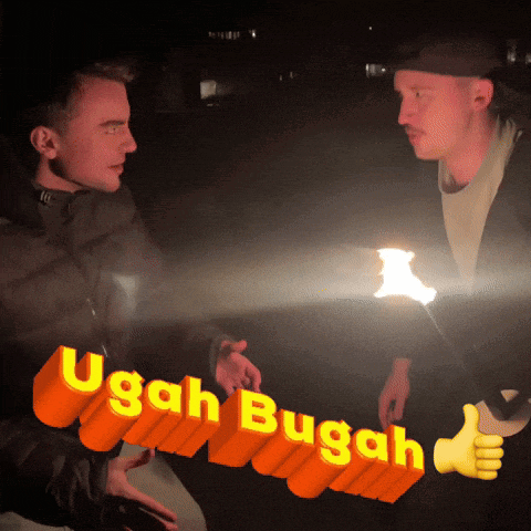 a man holding a sign that says ugah bugah