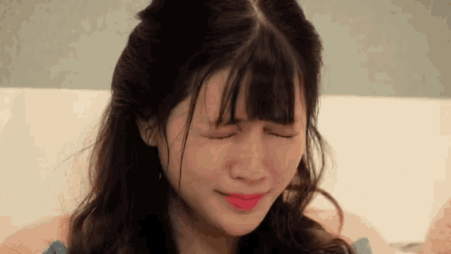a woman with her eyes closed and her mouth open