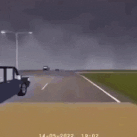 a cartoon car is driving down a road next to a tractor .