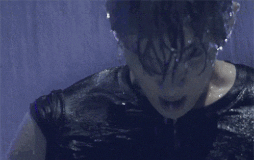 a close up of a person 's face with a black shirt on