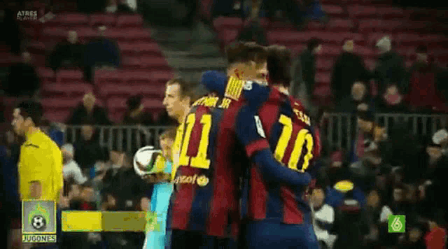 a group of soccer players hugging each other with the number 11 on their shirts