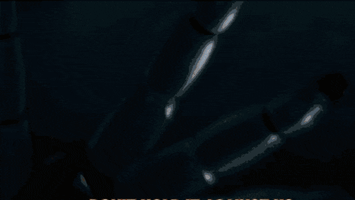 a blurred image of a car 's headlights with a few letters visible