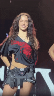 a woman wearing a black shirt that says ' dont tell anyone ' on it