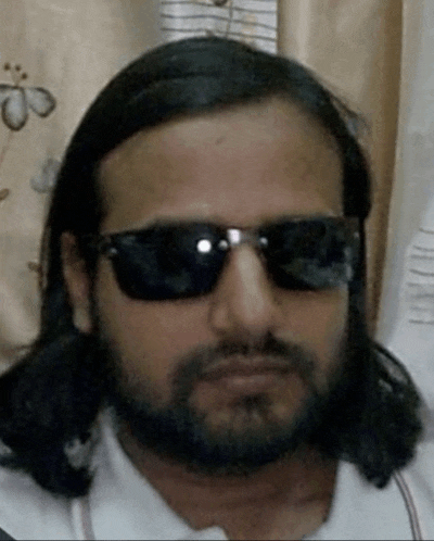 a man with long hair and a beard wearing sunglasses and a white shirt