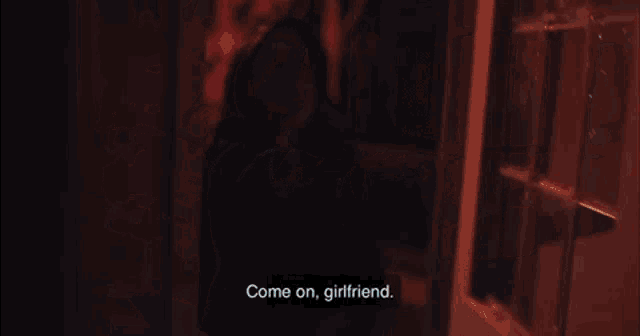 a woman is holding a gun in a doorway with the words come on girlfriend below her