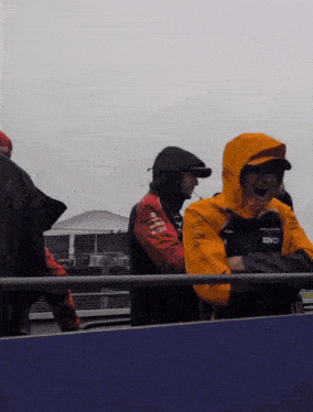a man wearing a yellow jacket that says ok on the front
