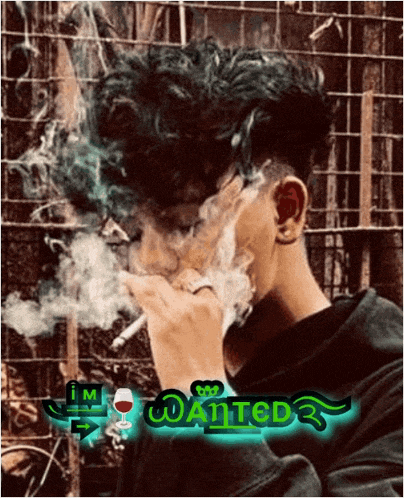 a young man is smoking a cigarette with a wanted logo on the bottom