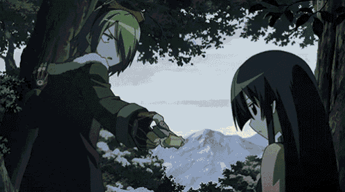 a man is pointing a gun at a woman in a forest