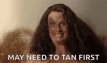 a woman with a lot of dirt on her face is smiling and saying may need to tan first .