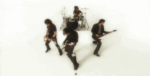a blurred image of a band with a drum set that says tama