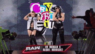a couple of women standing in front of a sign that says raw