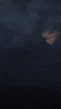 a close up of a fire coming out of a hole in the sky