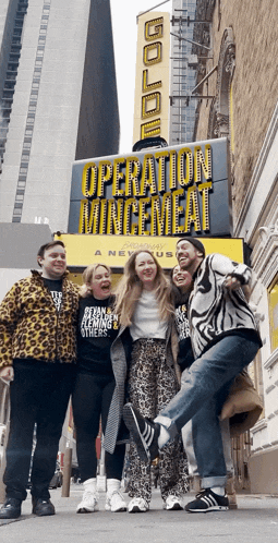 a group of people posing for a picture in front of a sign that says operation mincemeat