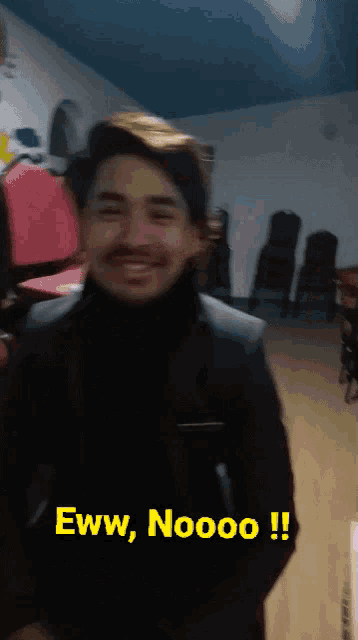 a man in a suit is smiling and says eww noooo !!