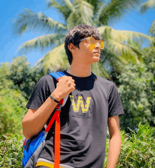 a man wearing sunglasses and a black shirt that says vw