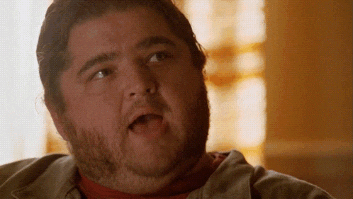 a fat man with a beard is making a funny face