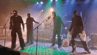 a group of masked men are performing on stage with a marshall amplifier in the background