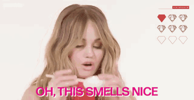 a woman is saying oh this smells nice