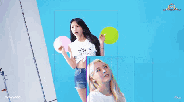 a woman wearing a white shirt that says swes is holding balloons