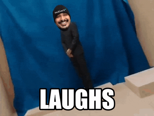 a man wearing a hat that says multivers on it laughs