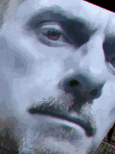 a close up of a man 's face with his eyes closed