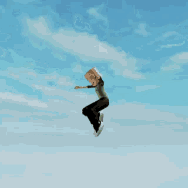 a cartoon character is jumping out of a box in the air .