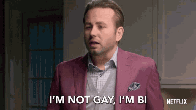 a man in a pink suit is saying i 'm not gay i 'm bi