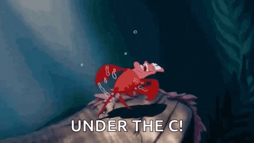 a crab is crawling on a rock with the words under the c written on it .