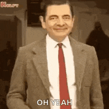 mr bean is wearing a suit and tie and saying oh yeah .