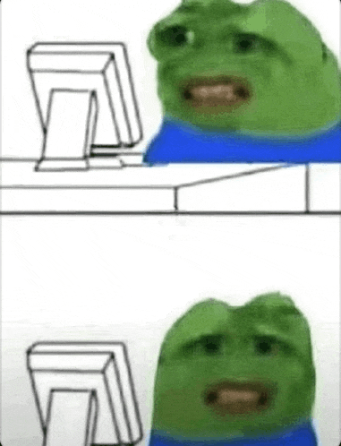a green frog is sitting in front of a computer screen .