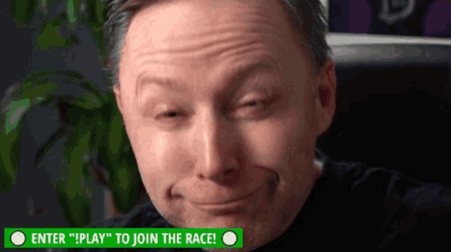 a man is smiling in front of a green sign that says " enter "