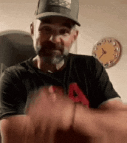 a man wearing a hat and a t-shirt with the letter a on it .