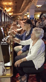 a group of people are playing slot machines in a casino .