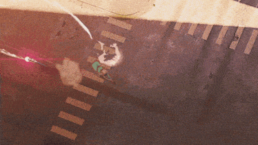 an aerial view of a person riding a skateboard on a city street