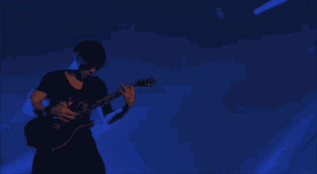 a man playing a guitar with a blue background