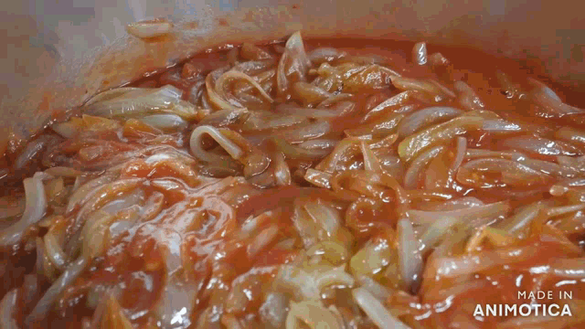 a sauce is being poured into a pot with the words made in animotica on the bottom
