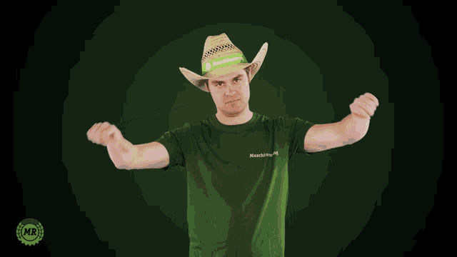 a man wearing a cowboy hat and a green shirt is giving a thumbs down sign